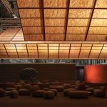 Glowing timber planes suspended over the dark Guest Lounge at ARCOmadrid 2026