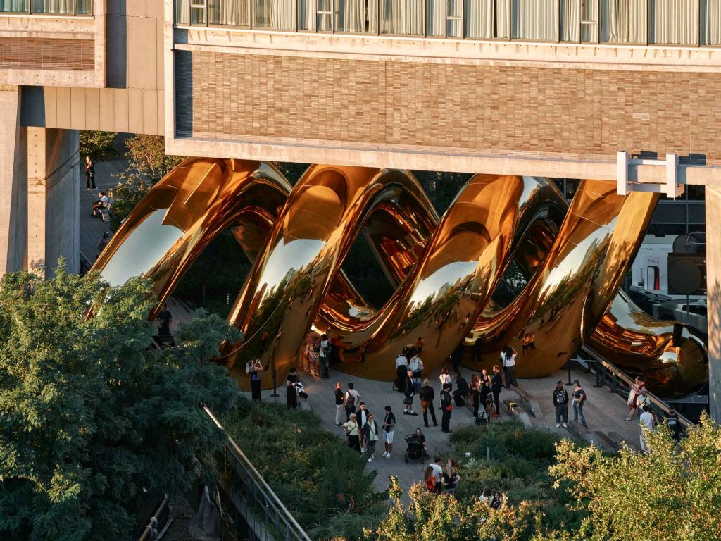 Visitors walking beneath the gold coils of auruBOROS on the High Line
