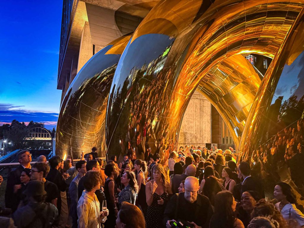 Crowd beneath auruBOROS at dusk
