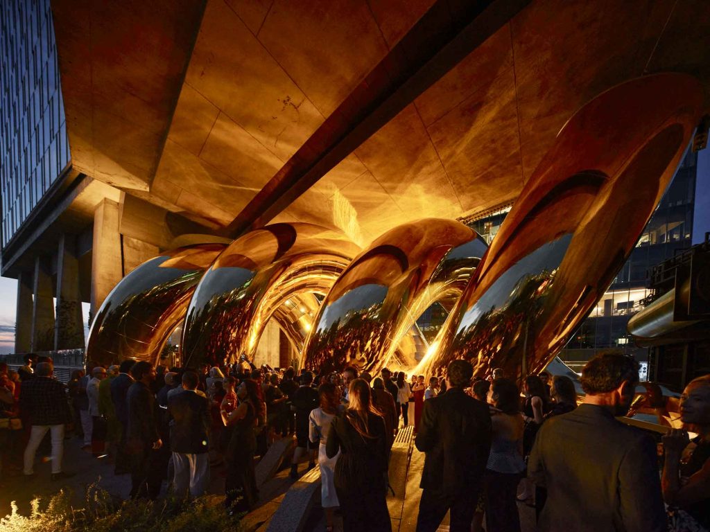 auruBOROS lit at night with visitors below