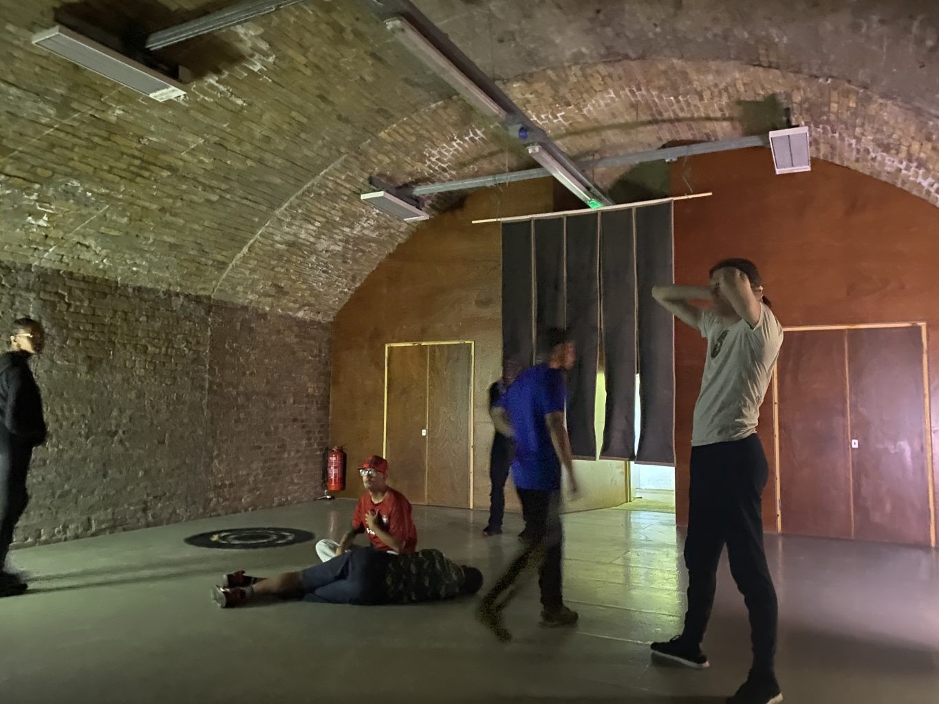 Projection and visitors in a brick railway arch