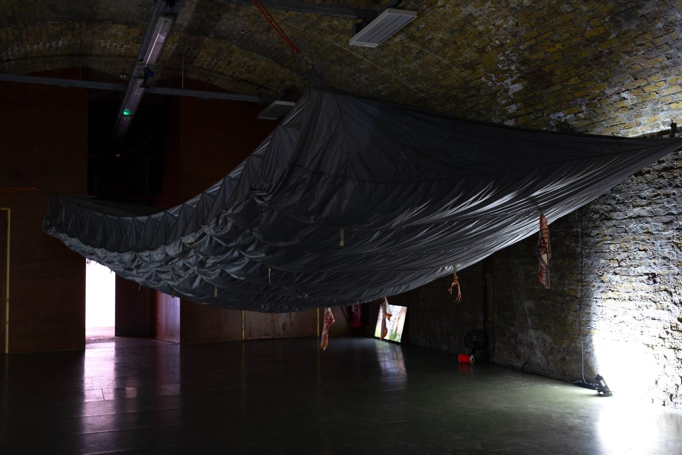Dark fabric draped in a brick arch