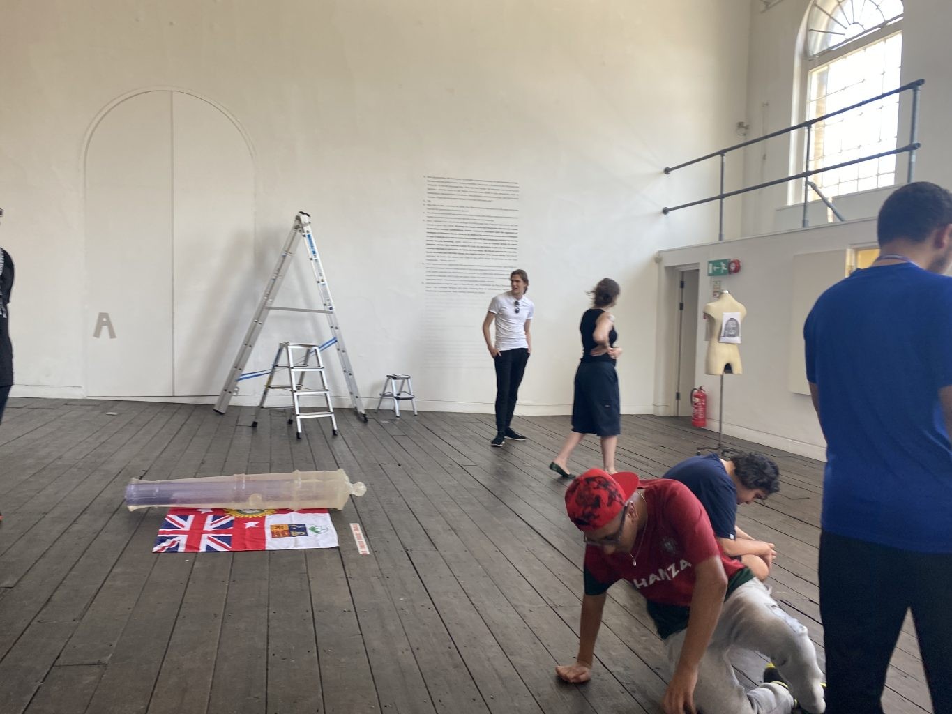 Workshop in a white gallery with ladders