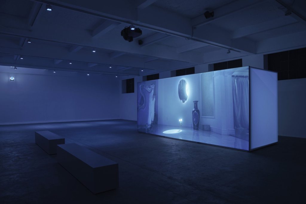 Freestanding projection screen in a dark gallery