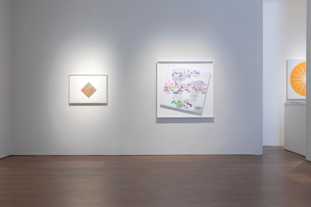 Abstract works hung across a white gallery