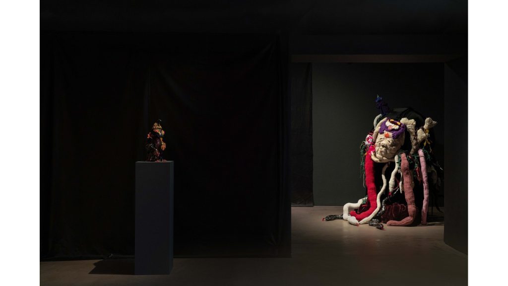 Sculptures on a plinth and in a dark room