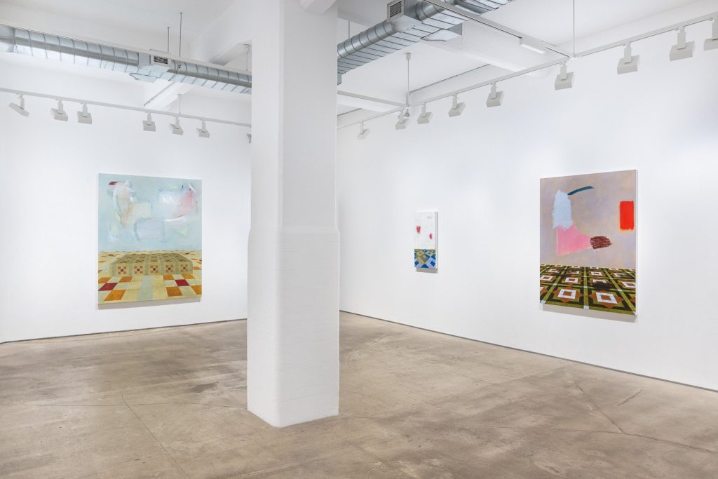 Ally Fallon paintings around a white column