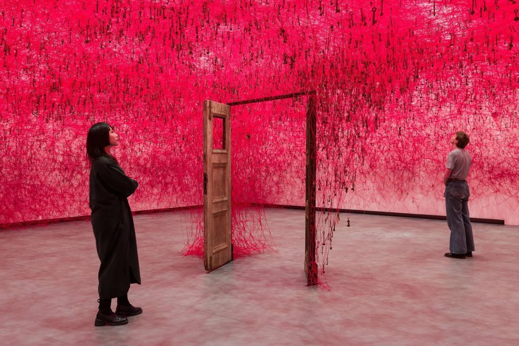 Red threads surrounding an open door