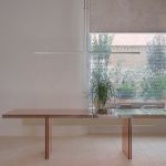 Table and planted courtyard window at IM Café, Madrid, by Nula Studio