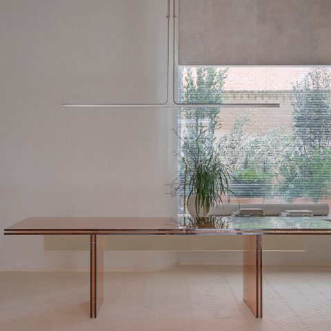 Table and planted courtyard window at IM Café, Madrid, by Nula Studio