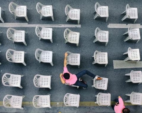 Rows of white monobloc chairs seen from above