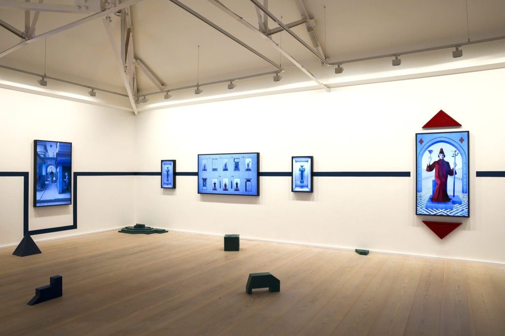 Screens and banners in a darkened gallery